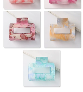 Detailed view of hollow square hair claws with premium marble patterns in various colors