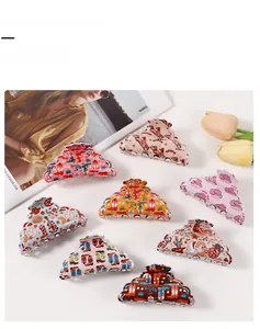 Detail of 8 Western-style hair claw clips with cowboy boots and cactus patterns