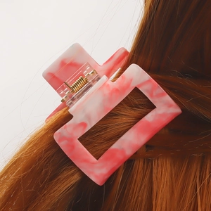 Pink and white marbled PVC square hair claw clip for women styled on long brown hair
