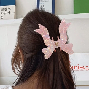 Iridescent pink butterfly hair claw clip for women shown on long brown hair from behind