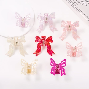 Set of 8 butterfly PVC hair claws in multi-color pastel finishes on white background