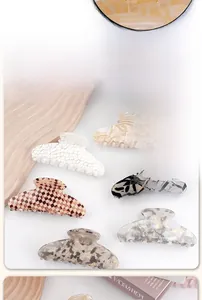 Detailed view of six vintage acetate claw clips with marble and plaid patterns for women