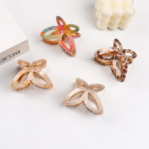 Set of four hollow butterfly hair claws in acetate finishes with golden metal springs
