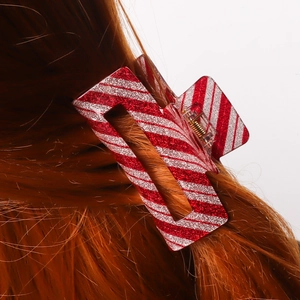 Christmas style red white striped glitter hair claw clip on brunette hair