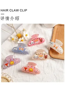 Detailed view of large shark hair claw clips with various cute cartoon animal prints