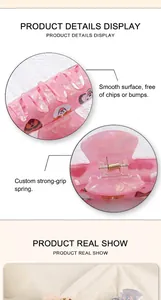 Detail of pink PVC hair claw clip showing custom metal spring and cartoon floral prints