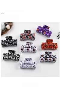 Set of eight Halloween hair claw clips featuring pumpkin, bat, and ghost motifs in festive colors