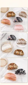 Detail view of marble pattern acetate hair claw clips with high-quality metal springs
