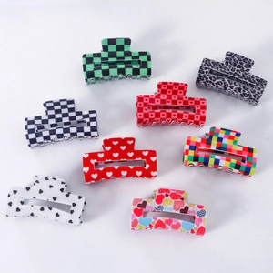 Collection of large PVC hair claws in checkered, leopard print, and heart patterns