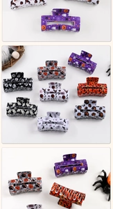 Detail of Halloween hair clips featuring pumpkin, bat, and spider web festive designs