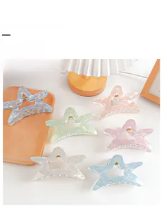 Set of six colorful star-shaped hair claw clips in pearl finish with gold springs