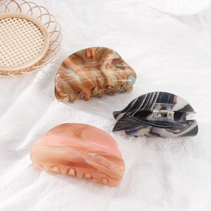 Three half-round marble pattern acetate hair claws in brown, grey and peach colors