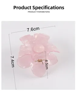 Detailed macro view showing pink plumeria hair claw clip dimensions and resin texture