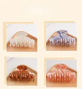 Close-up of hair claws in marble and checkered patterns with four color variants
