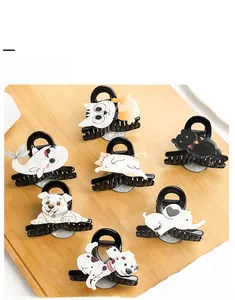 Flat lay of colorful acetate hair claw clips in cartoon cat and dog shapes
