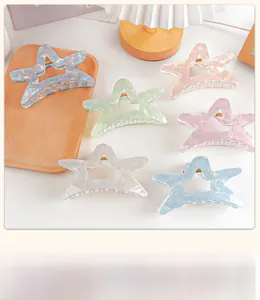 Set of 6 colorful star-shaped hair claws in iridescent acrylic with golden metal springs
