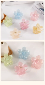 Detail of colorful flower hair claw clips with pearlescent marble texture and metal spring