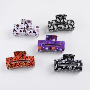 Set of 5 Halloween hair claws with pumpkin, bat, and ghost designs on white background
