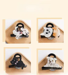 Detailed grid view of four cute cartoon dog and cat acrylic hair claws on a wooden tray