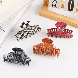 Set of four large hair claws in checkerboard and marble patterns for thick hair