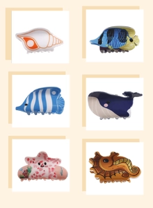 Detail showing set of six sea creature hair claws including whale and starfish designs