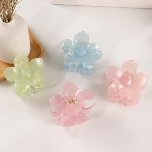 Iridescent plumeria flower hair claws in pastel colors with pearlescent finish