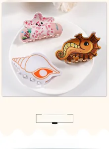 Detail of colorful ocean themed hair claws with sea star, seahorse and shell designs