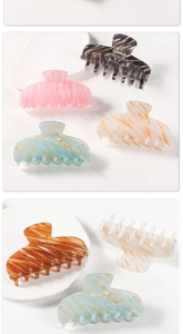 Detail showing various marble and tortoiseshell patterns on large hair claw clips