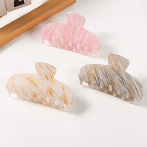 Three marble texture hair claws in pink, cream, and grey with a high-shine finish