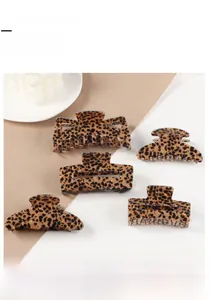 Detailed close-up of diverse leopard print acrylic hair claw clips in various shapes