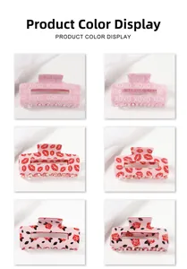 Detail view of large square hair claws featuring XOXO, red lips, and rose patterns