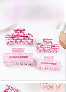 Detailed view of four Bride themed hair claws in pink and white acrylic for wedding parties