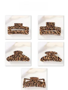 Close-up of leopard print hair claw clips in various shapes with glossy finish
