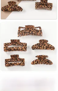 Detail view of five assorted leopard print hair claw clips in various shapes and sizes