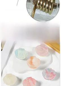 Detail of strong metal spring and pearlescent shell hair clips in various colors