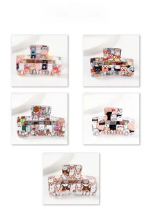 Detail of five rectangular hair claws with cartoon animal patterns and hollow design