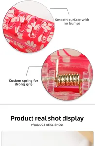 Detail of red floral hair claw clip showing smooth resin surface and strong metal spring