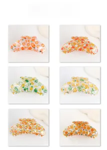 Detailed grid display of six colorful fruit print hair claws with lemon and orange patterns