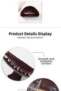 Detail of smooth dark amber hair claw clip with high gloss finish and strong metal spring