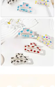 Close-up of cute acetate hair claw clips with various sweet patterns on a display stand