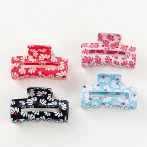 Set of four floral hair claws with daisy and heart patterns in red, pink, blue and navy