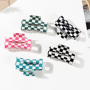 Five checkerboard hair claws in green, pink, blue and classic black and white colors