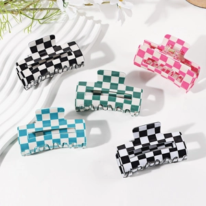 Checkered hair claw clips set in black, pink, blue and green on white aesthetic background