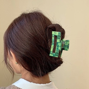 Green St. Patrick's Day hair claw clip with shamrock patterns for thick hair