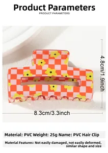 Macro shot of red and white checkered hair claw clip with floral pattern detail
