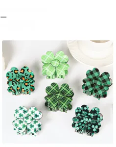 Detail view showing six green shamrock hair claw clips with various clover and plaid patterns