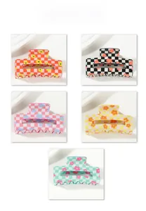 Detail display of five checkerboard hair claws with floral patterns in various colors