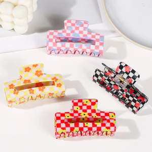 Set of four checkerboard floral hair claws in pink, yellow, and red for thick hair styling