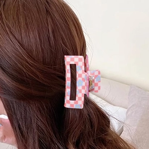 Pink and white checkerboard hair claw with blue floral patterns for thick hair styling