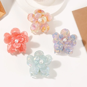 Set of four colorful pearl floral hair claws with elegant marble texture patterns